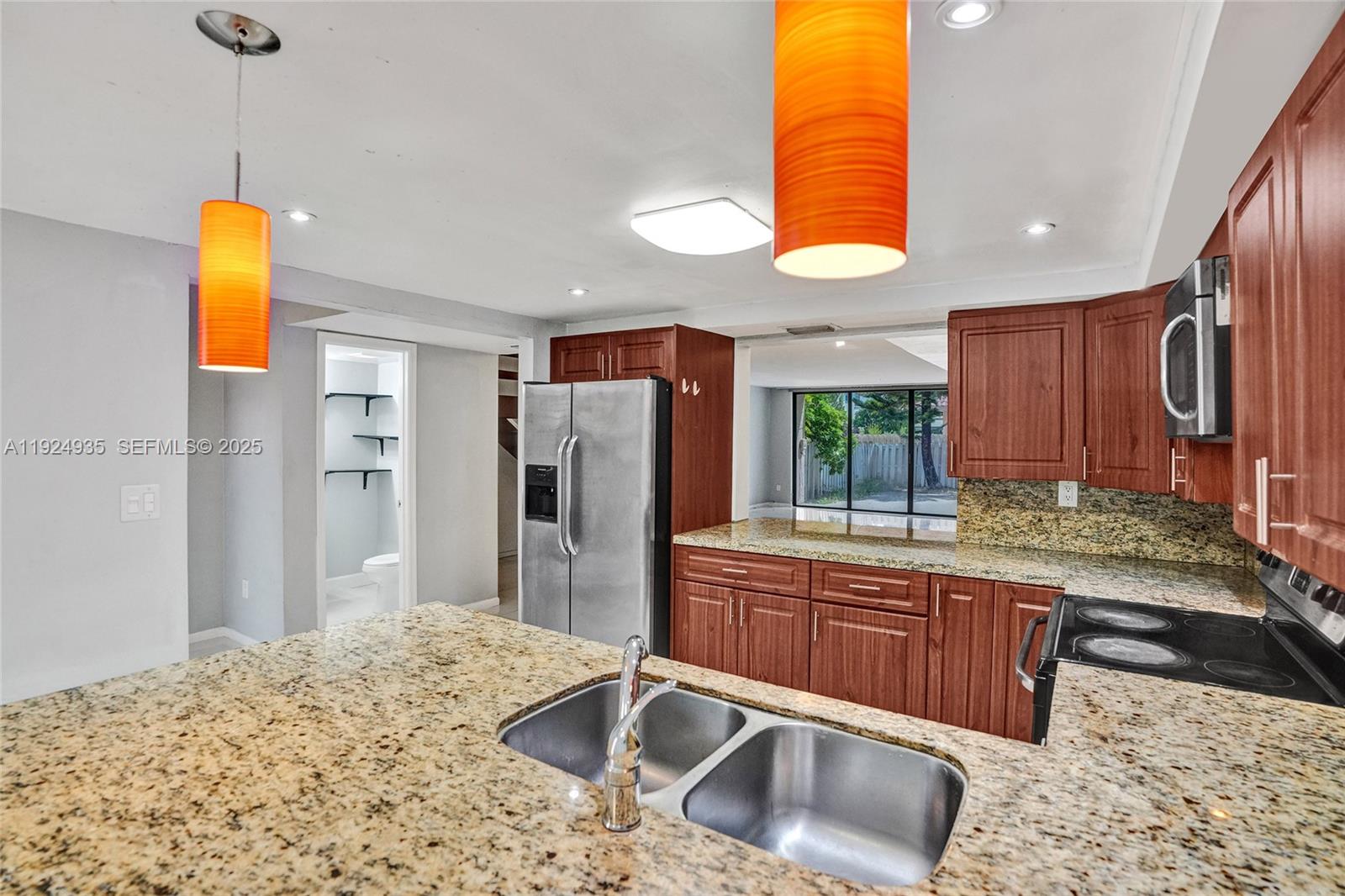 20607 Northeast 7th Court Miami, FL 33179 - Photo 7 of 49 a kitchen with stainless steel appliances granite countertop a sink and a refrigerator