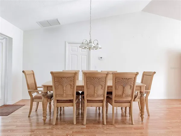 a large white kitchen with stainless steel appliances cabinets a sink and a window