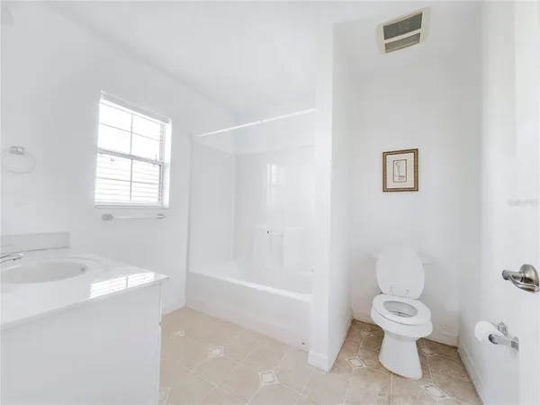 a backyard of a house with barbeque oven table and chairs