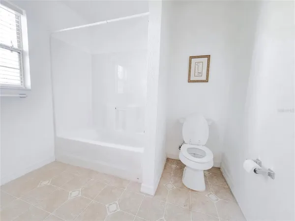 an aerial view of a house with a yard and plants