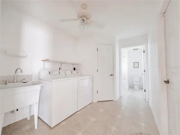 an aerial view of a house with a yard and greenery