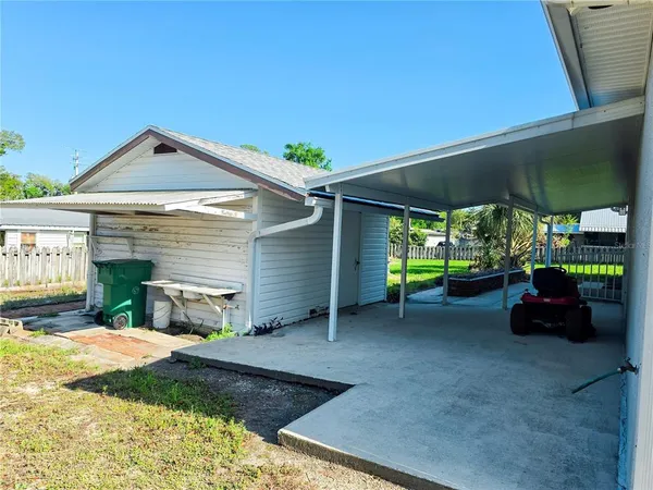a view of a backyard with sitting area