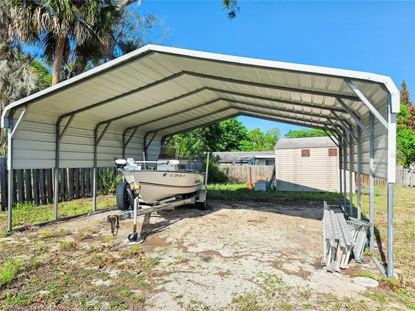 a view of a house with a backyard porch and sitting area
