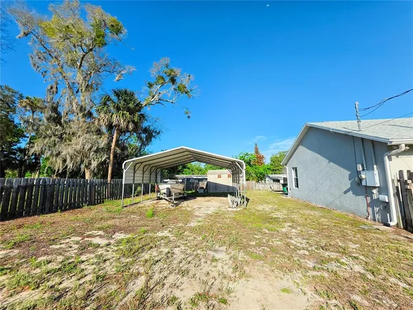 a view of a garden with houses in the background