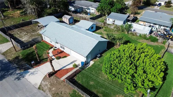 a view of a porch with furniture and a yard