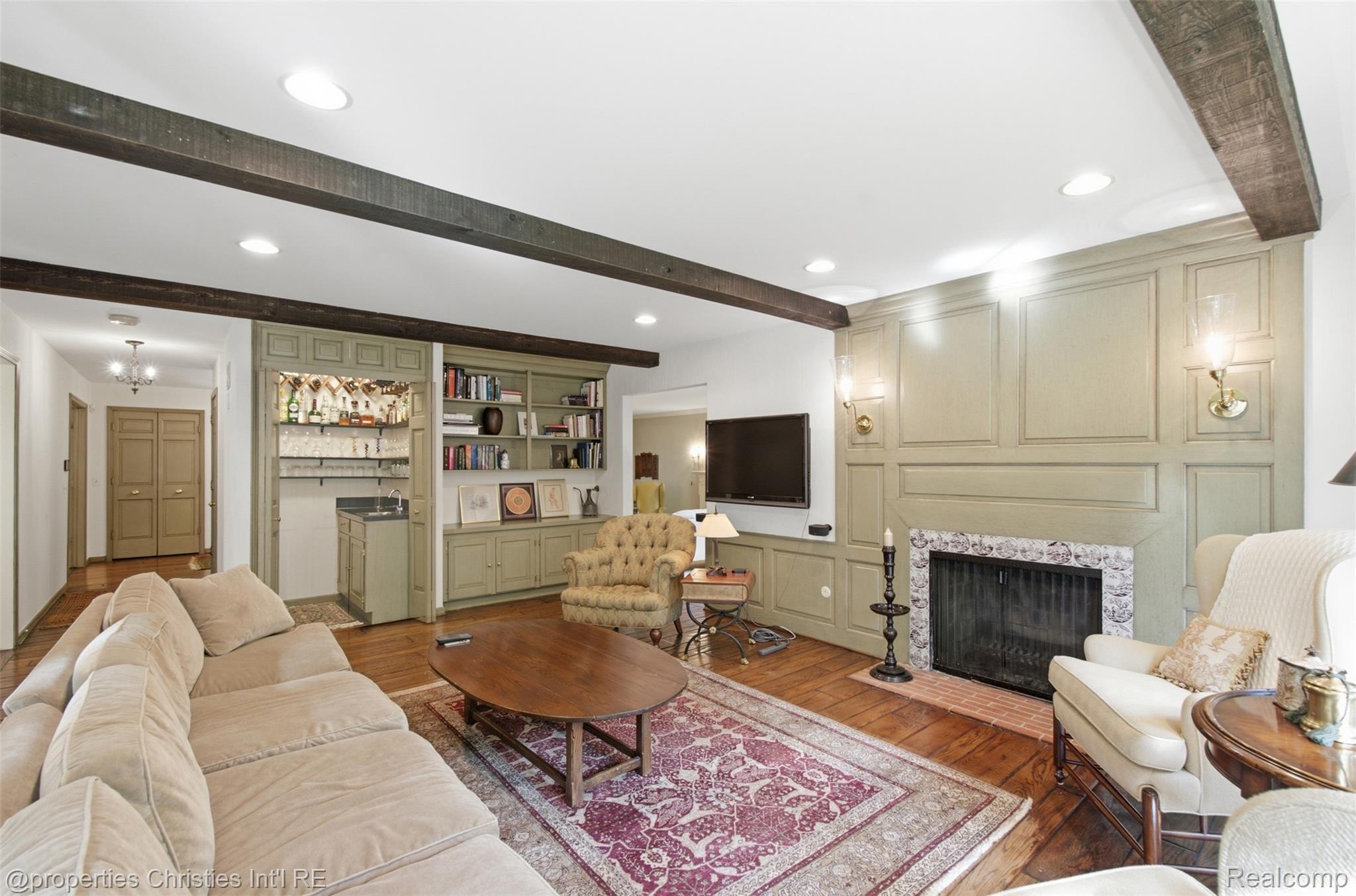 25235 Canterbury Road Franklin, MI 48025 - Photo 14 of 56 Great room featuring exposed wood beams, recessed lighting, wet bar (could be converted to elevator to second floor) and natural fireplace