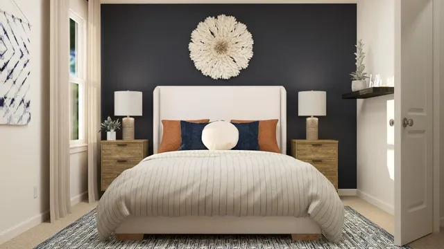 a bedroom with a bed and painting on the wall