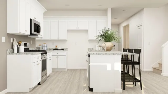 a kitchen with cabinets and chair