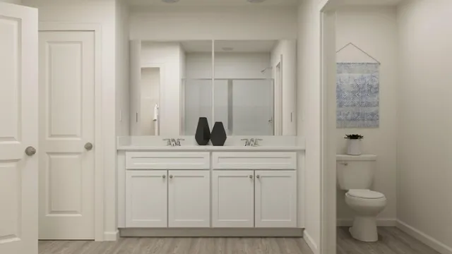 a bathroom with a toilet a sink and mirror