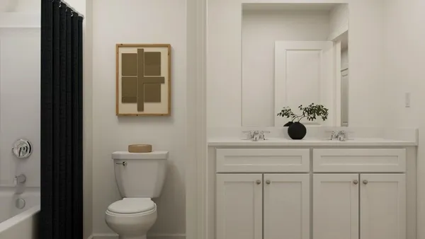 a bathroom with a sink and mirror with toilet