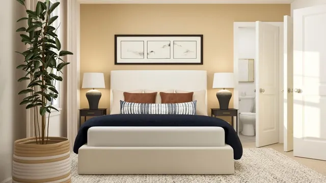 a bed sitting in a bedroom next to a window and chair