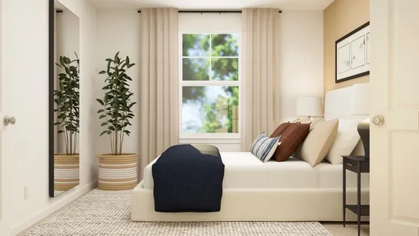 a bedroom with a large window and a bed