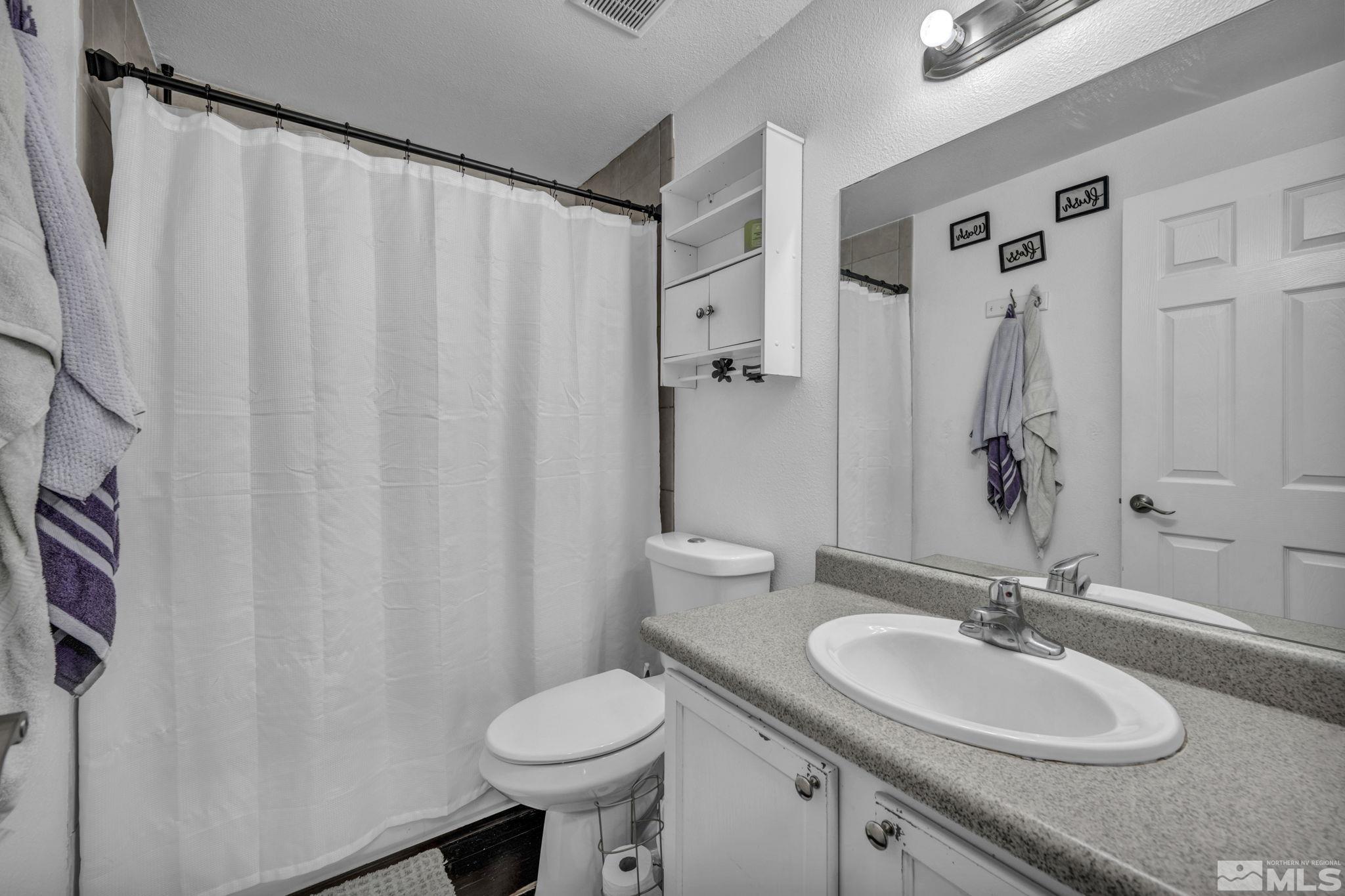 6805 Peppermint Drive Reno, NV 89506 - Photo 17 of 26 a bathroom with a sink and a mirror
