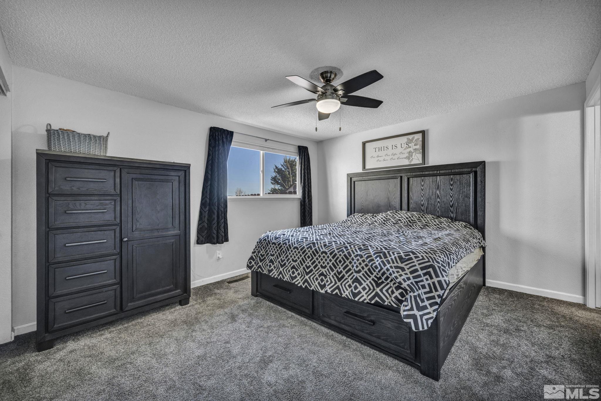 6805 Peppermint Drive Reno, NV 89506 - Photo 18 of 26 a bedroom with a bed and a chandelier