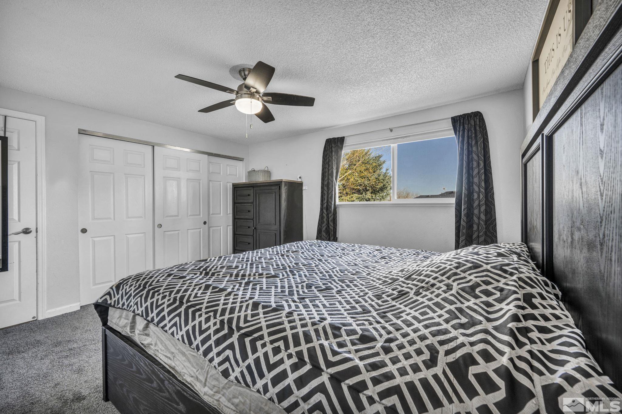 6805 Peppermint Drive Reno, NV 89506 - Photo 19 of 26 a bedroom with a bed and painting on the wall