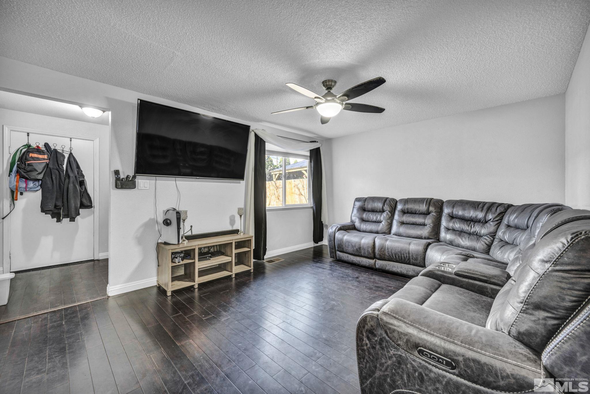 6805 Peppermint Drive Reno, NV 89506 - Photo 5 of 26 a living room with furniture and a flat screen tv