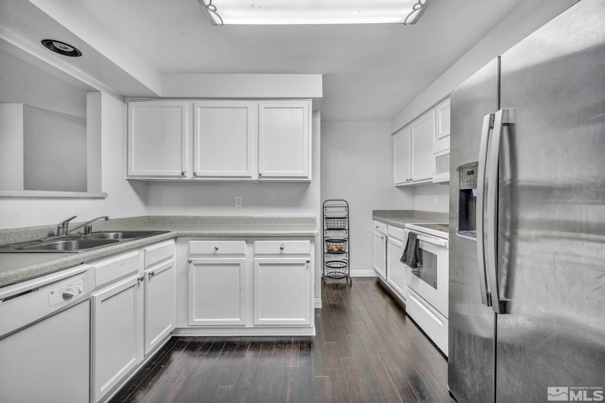 6805 Peppermint Drive Reno, NV 89506 - Photo 6 of 26 a kitchen with white cabinets and white appliances