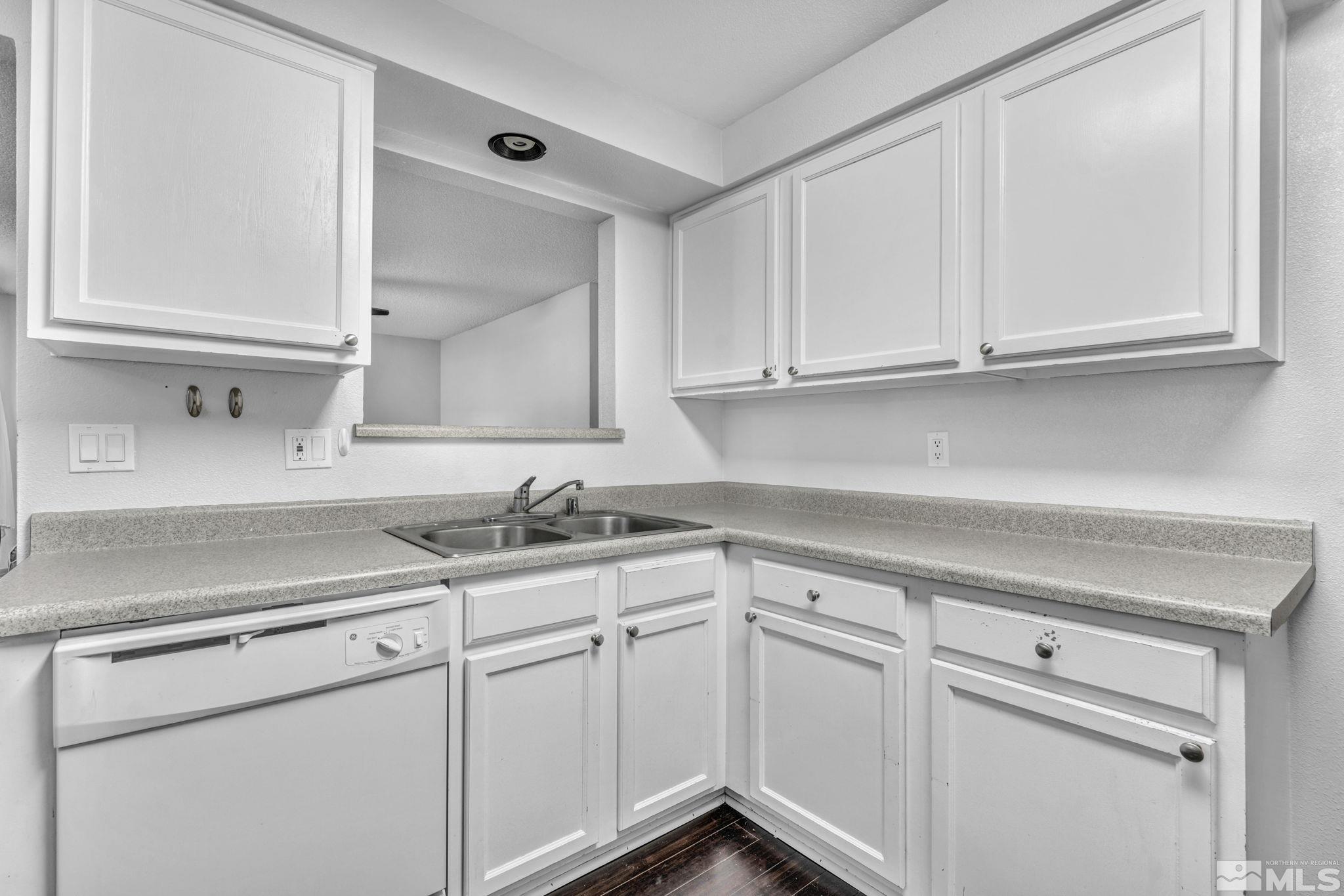 6805 Peppermint Drive Reno, NV 89506 - Photo 7 of 26 a kitchen with white cabinets and white appliances