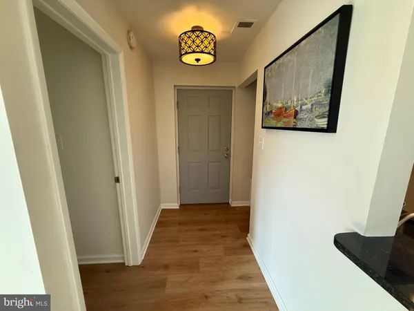 a view of a hallway with wooden floor