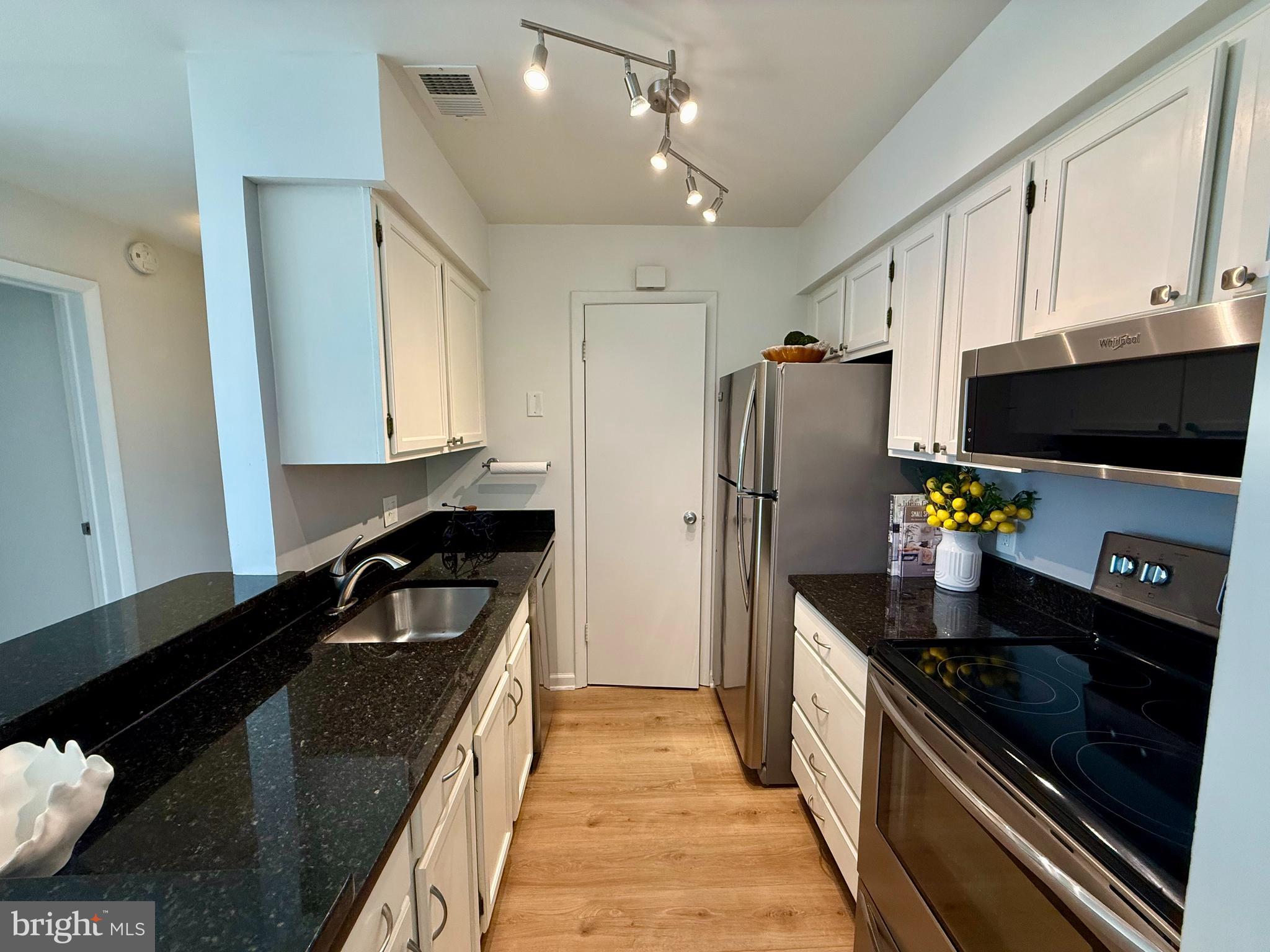 5355 Smooth Meadow Way, Unit 5 Columbia, MD 21044 - Photo 6 of 26 a kitchen with stainless steel appliances a sink stove and refrigerator