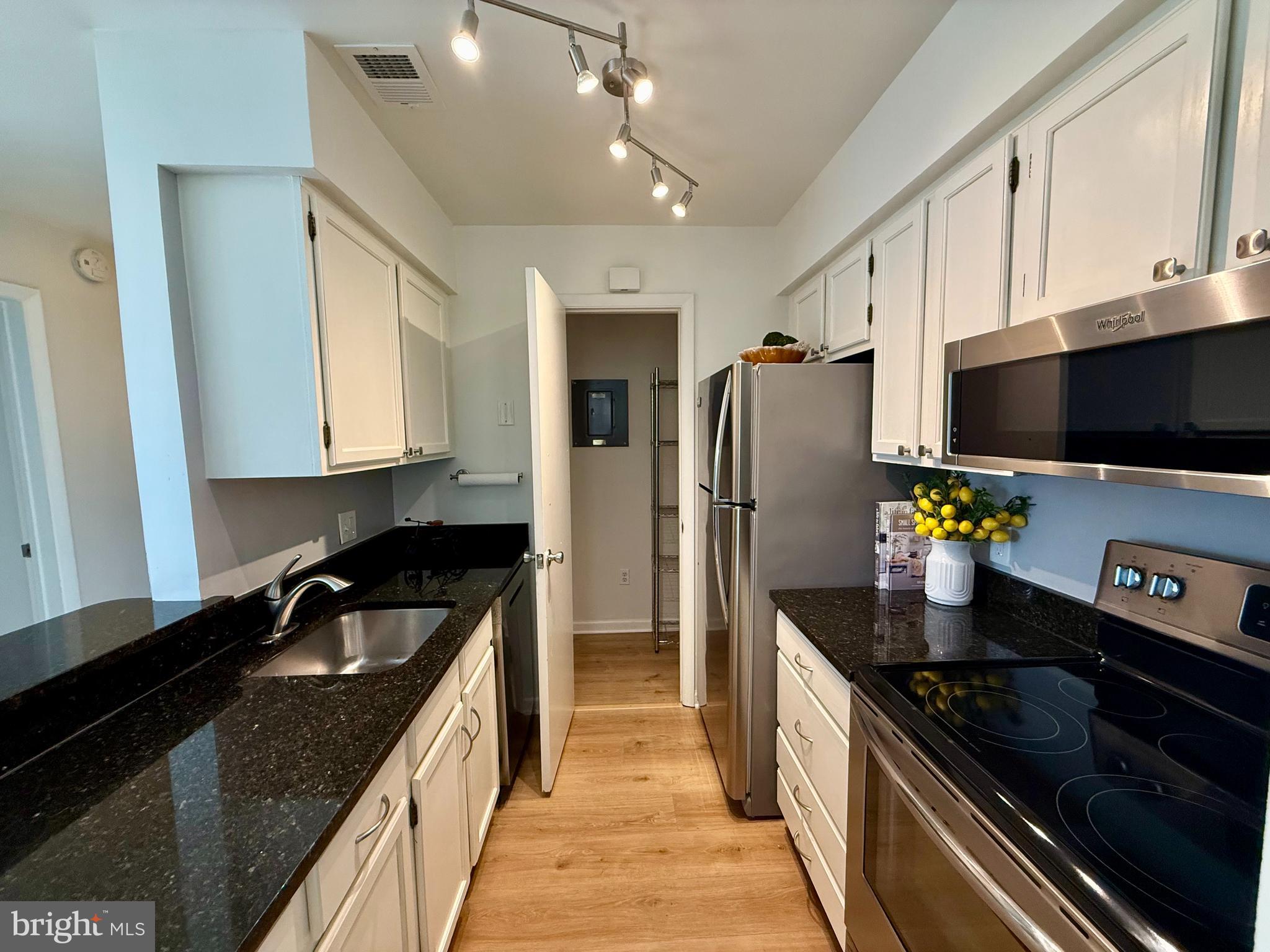 5355 Smooth Meadow Way, Unit 5 Columbia, MD 21044 - Photo 7 of 26 a kitchen with stainless steel appliances granite countertop a sink stove and refrigerator
