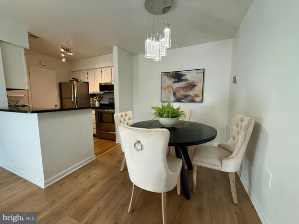 a view of a dining room with furniture and wooden floor