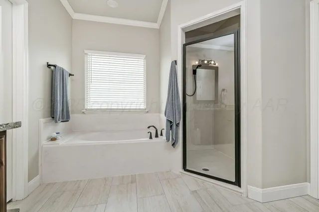 a spacious bedroom with a bed and a flat screen tv