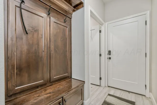 a view of a green field with wooden fence