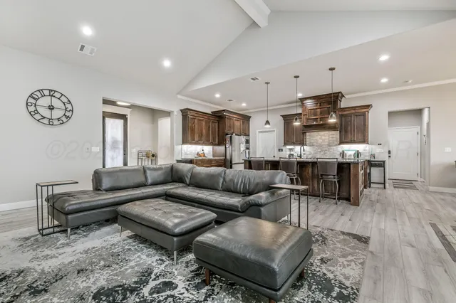 a living room with furniture kitchen view and a table