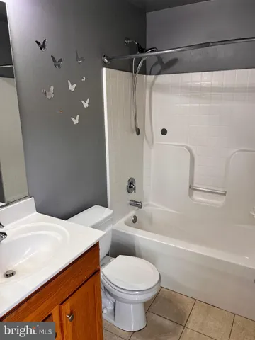 a bathroom with a sink toilet vanity and shower