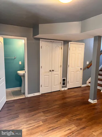 a view of wooden floor and windows in a room