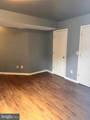 a view of an empty room and wooden floor