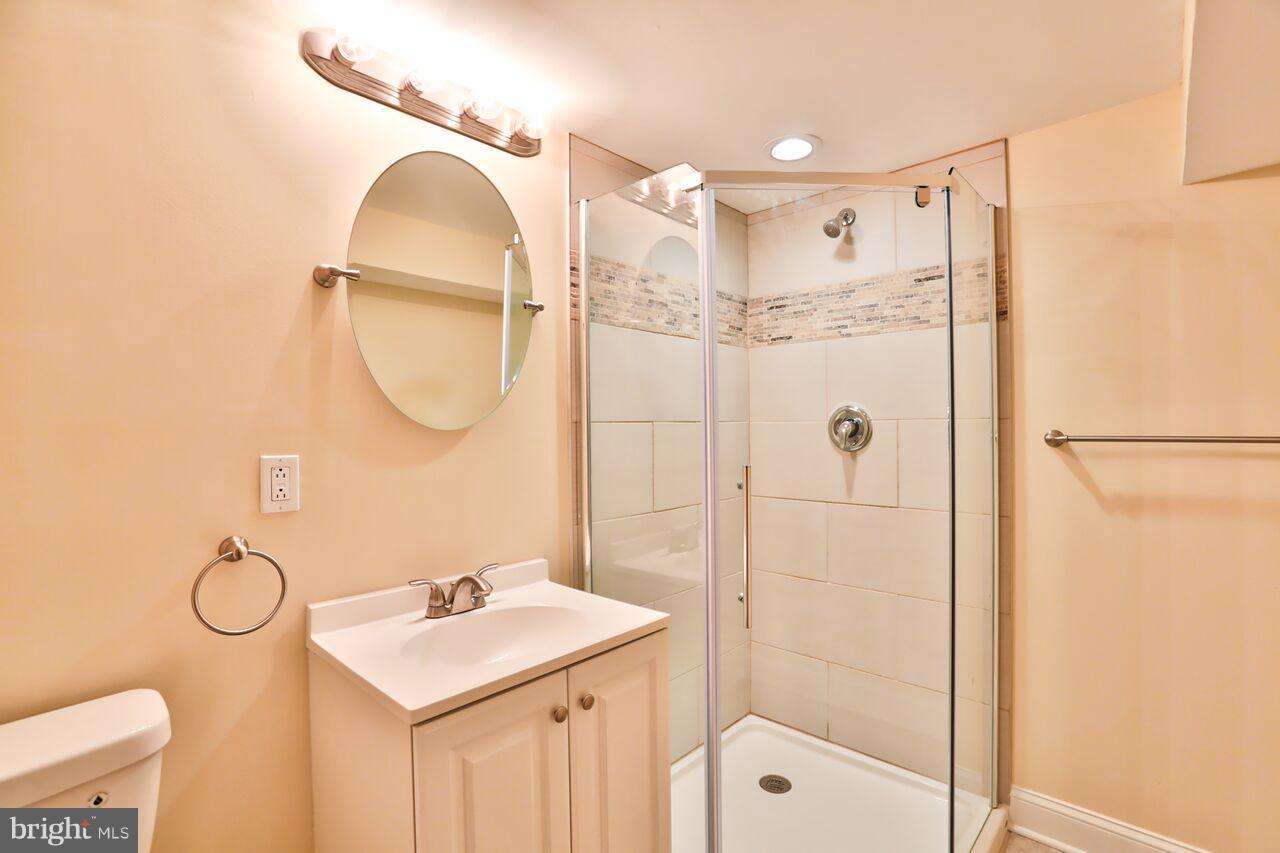5136 Stafford Road Baltimore, MD 21229 - Photo 23 of 30 a bathroom with a sink mirror and shower