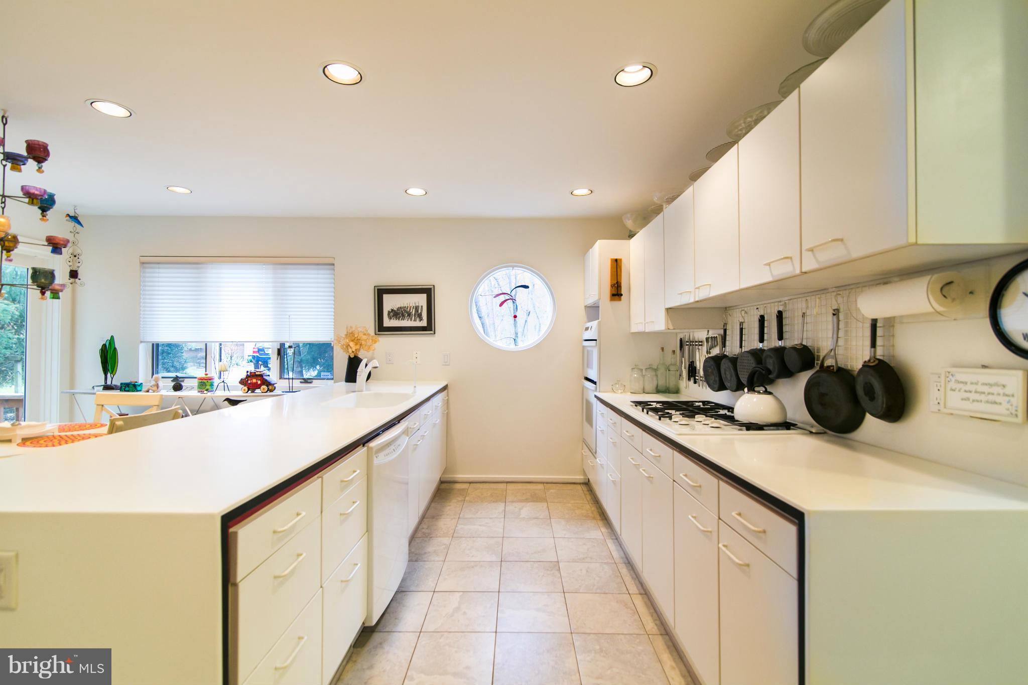 11915 State Rte 4707 Reston, VA 20191 - Photo 11 of 30 a large white kitchen with a large window