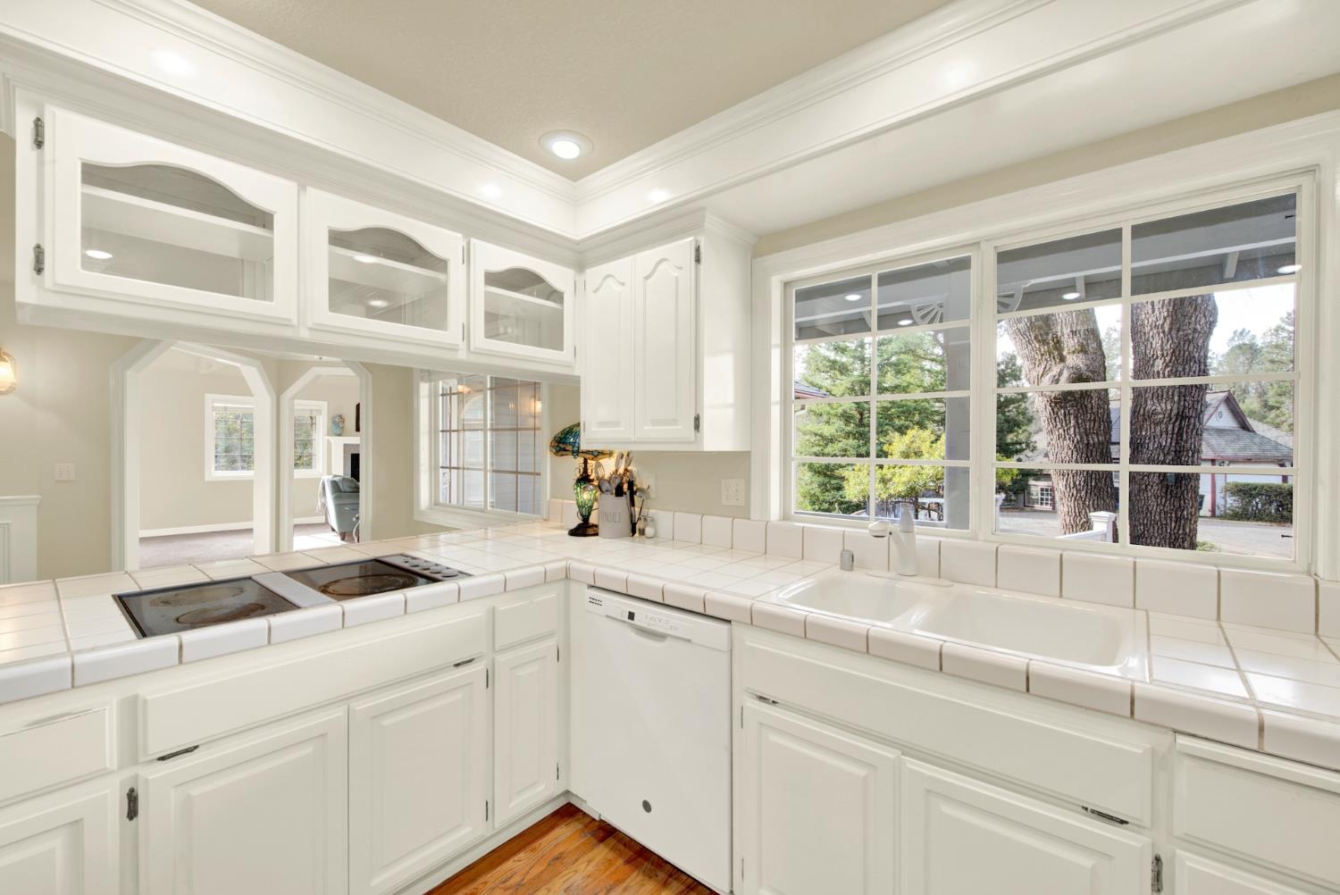 2812 Bronzecrest Street Placerville, CA 95667 - Photo 32 of 74 a kitchen with stainless steel appliances granite countertop a sink and white cabinets next to a window