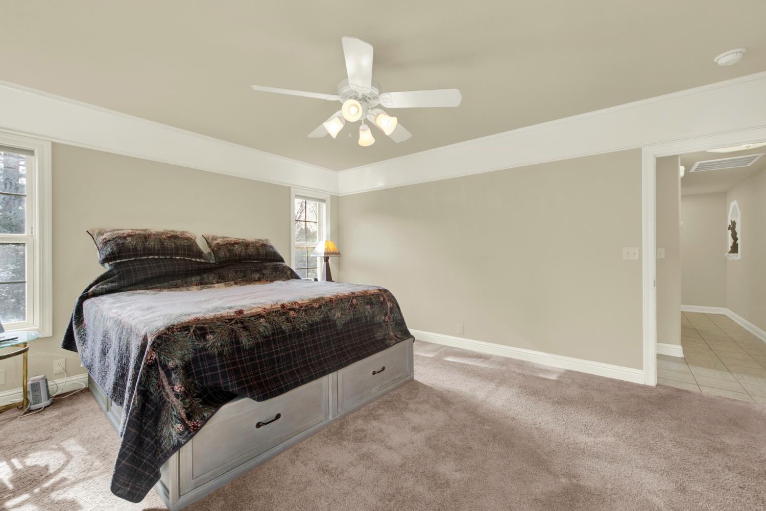 2812 Bronzecrest Street Placerville, CA 95667 - Photo 36 of 74 a bedroom with a bed and a chandelier