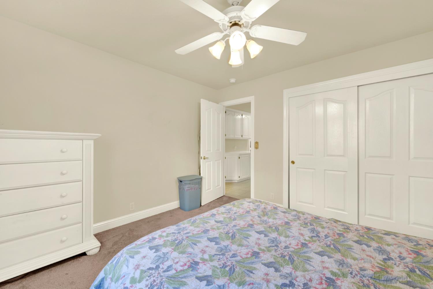 2812 Bronzecrest Street Placerville, CA 95667 - Photo 44 of 74 a bedroom with a bed and a chandelier fan