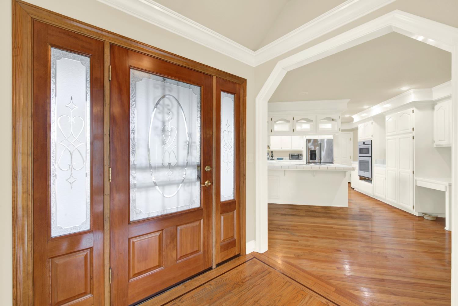 2812 Bronzecrest Street Placerville, CA 95667 - Photo 7 of 74 a view of a hallway with wooden floor and a kitchen