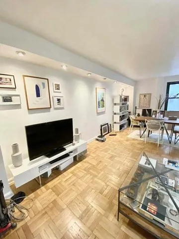 a view of a livingroom with furniture and a flat screen tv