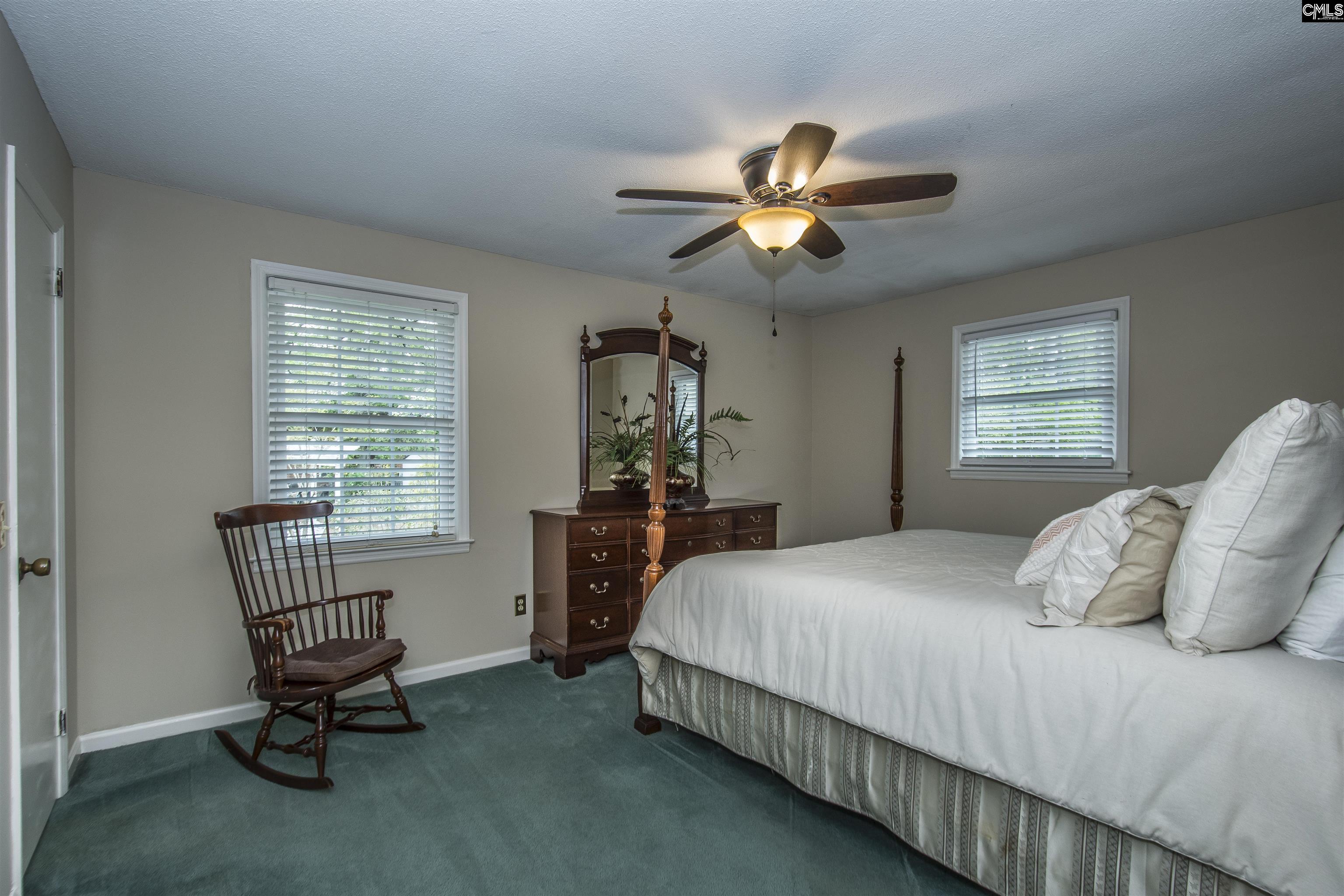 2309 Cunningham Road Columbia, SC 29210 - Photo 36 of 41 a bedroom with a bed a chair and gym equipment