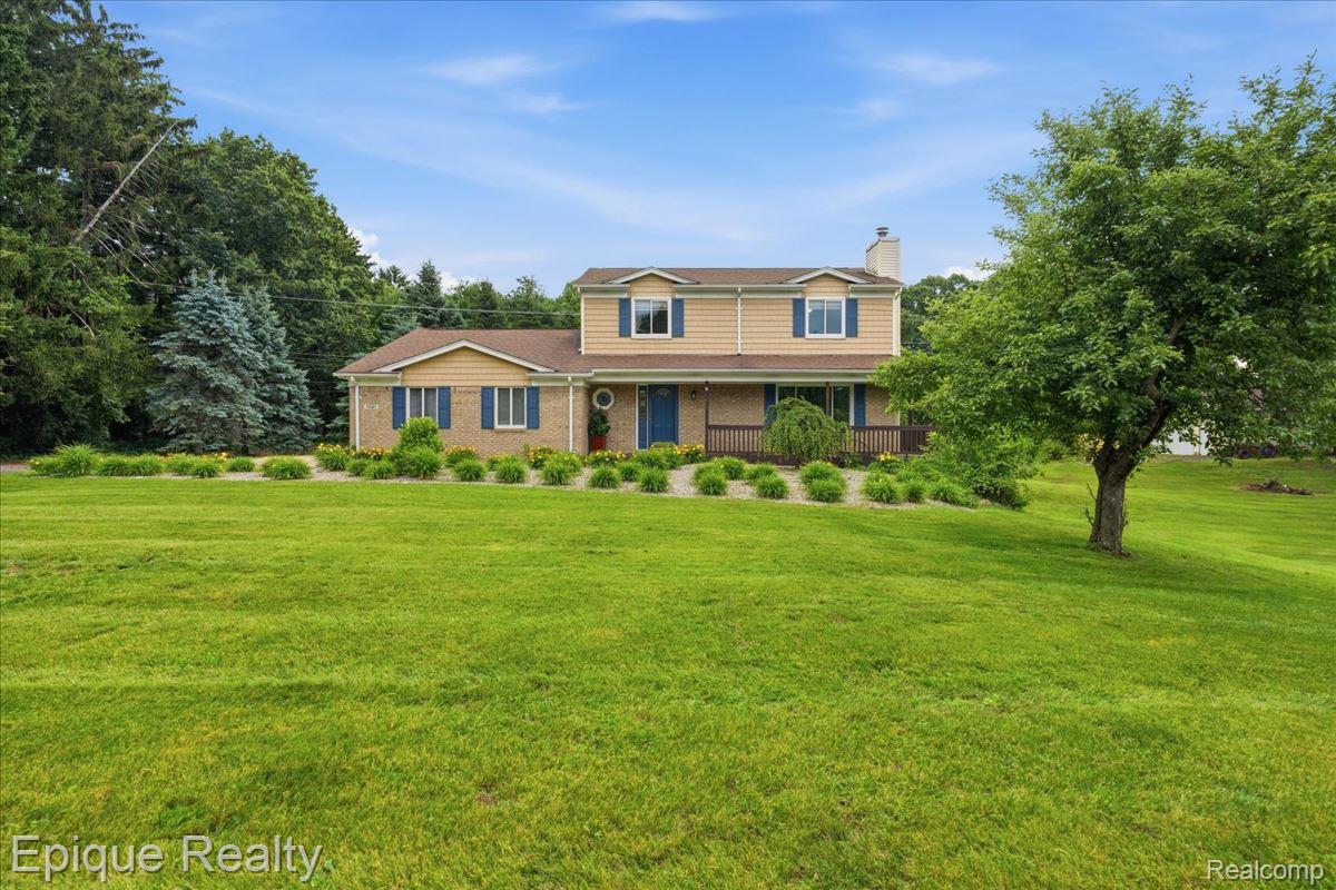 1221 Rhodes Road Lake Orion, MI 48360 - Photo 1 of 72 Two-story residence featuring brick and siding facade with blue shutters