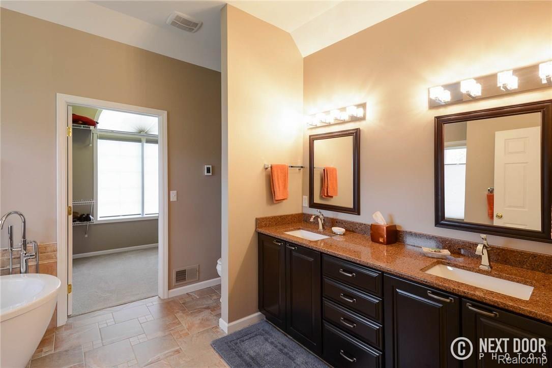 4886 Pleasant Valley Road Brighton, MI 48114 - Photo 23 of 51 Master bath, with quartz counters, heated tile floors, soaking tub and walk in closet.