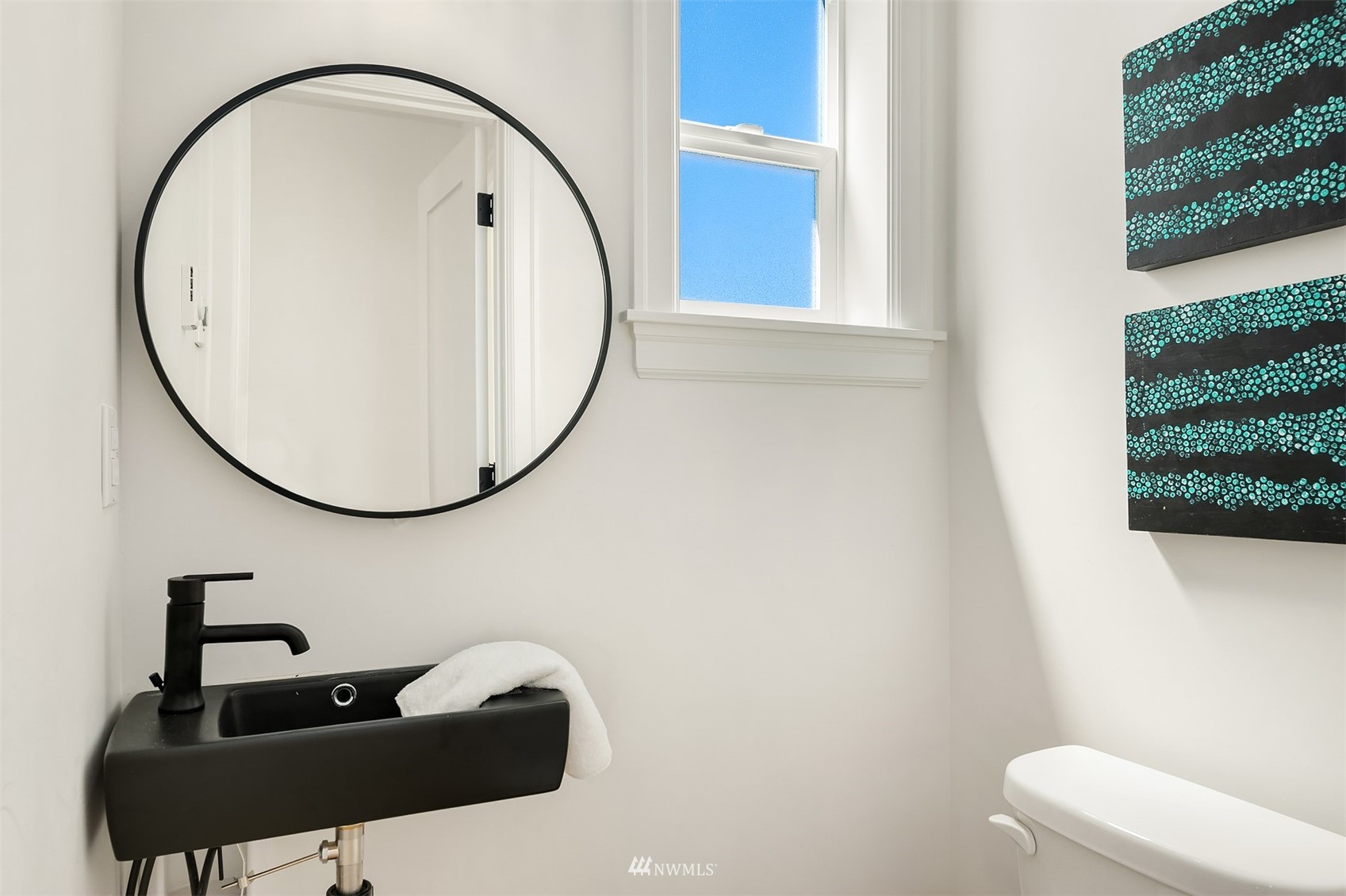 8041 Stroud Avenue North, Unit B Seattle, WA 98103 - Photo 13 of 29 a bathroom with a sink and a mirror