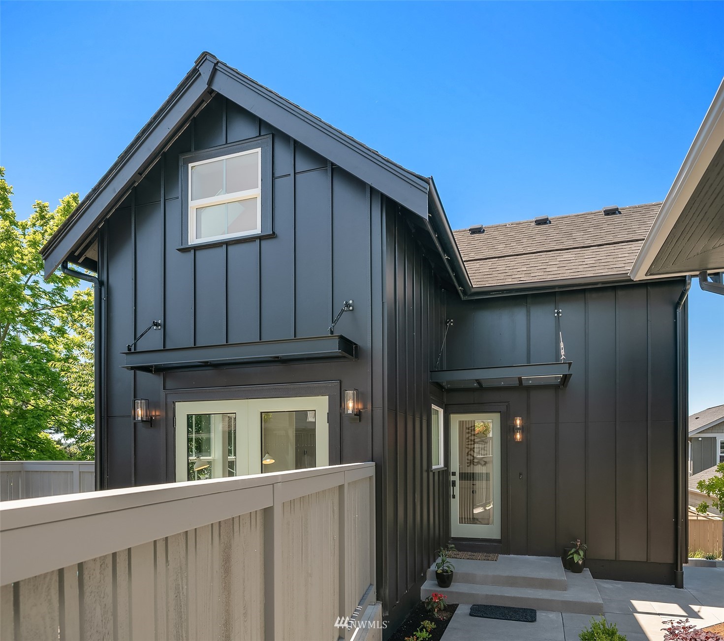 8041 Stroud Avenue North, Unit B Seattle, WA 98103 - Photo 2 of 29 a view of a house with wooden fence and large windows