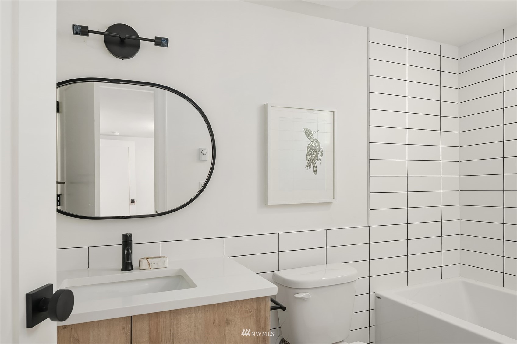 8041 Stroud Avenue North, Unit B Seattle, WA 98103 - Photo 21 of 29 a bathroom with a sink and a mirror