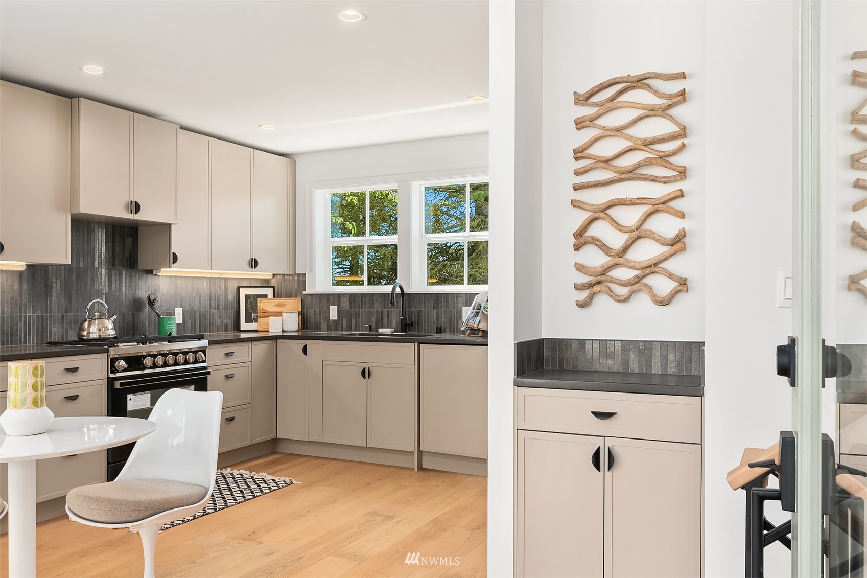 8041 Stroud Avenue North, Unit B Seattle, WA 98103 - Photo 3 of 29 a kitchen with stainless steel appliances a stove a sink and a refrigerator