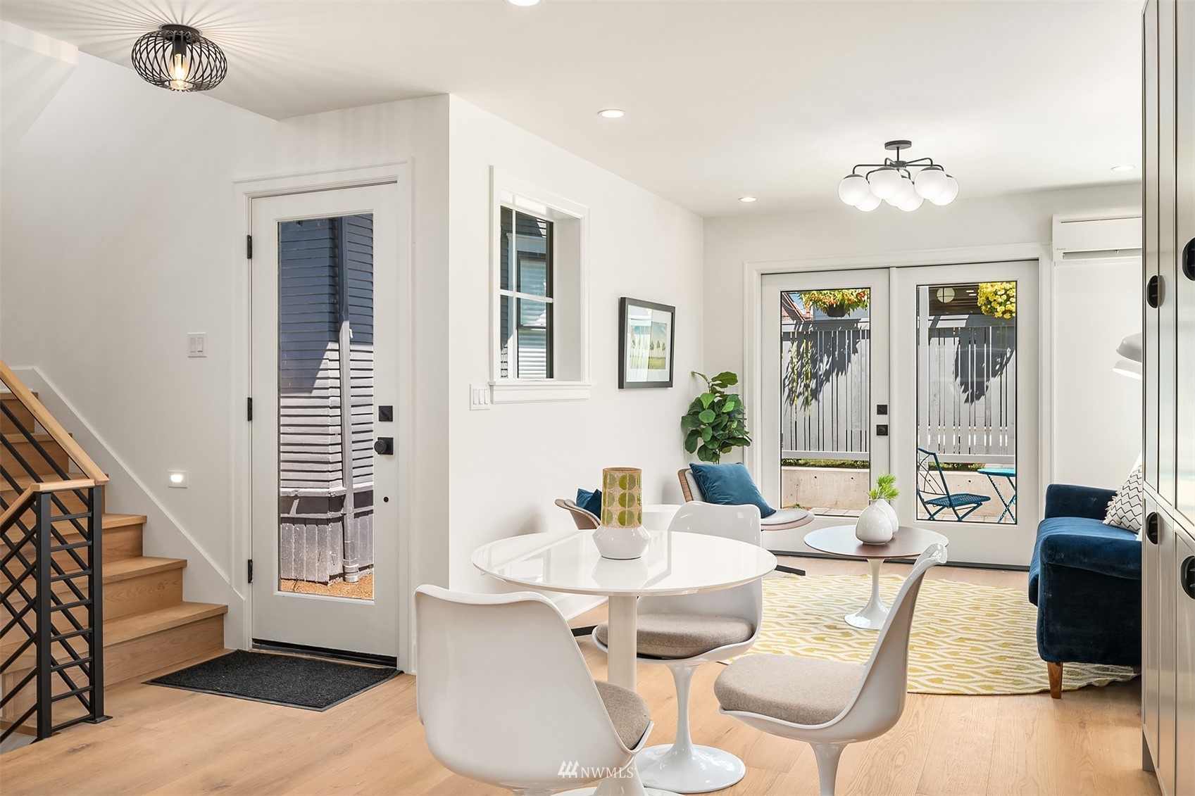 8041 Stroud Avenue North, Unit B Seattle, WA 98103 - Photo 8 of 29 a living room with furniture and a chandelier