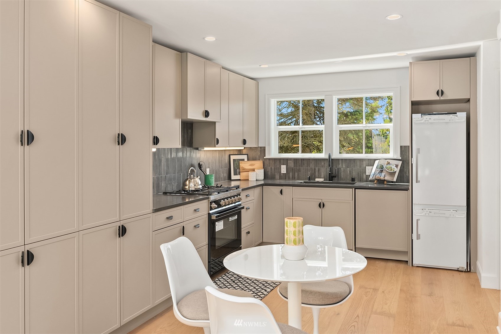 8041 Stroud Avenue North, Unit B Seattle, WA 98103 - Photo 9 of 29 a kitchen with granite countertop white cabinets and white appliances