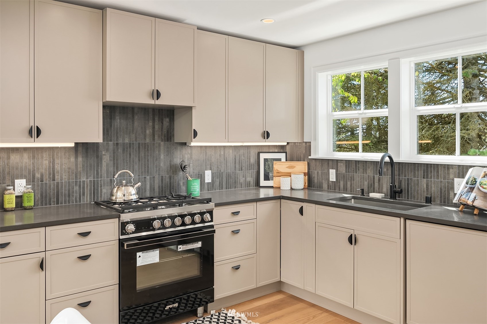 8041 Stroud Avenue North, Unit B Seattle, WA 98103 - Photo 10 of 29 a kitchen with granite countertop white cabinets and white stainless steel appliances