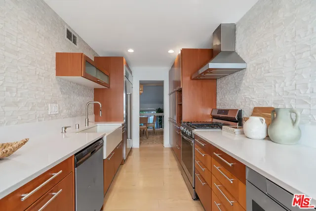 a kitchen with stainless steel appliances a sink and a stove